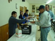 Adam B. serves milk to customers.